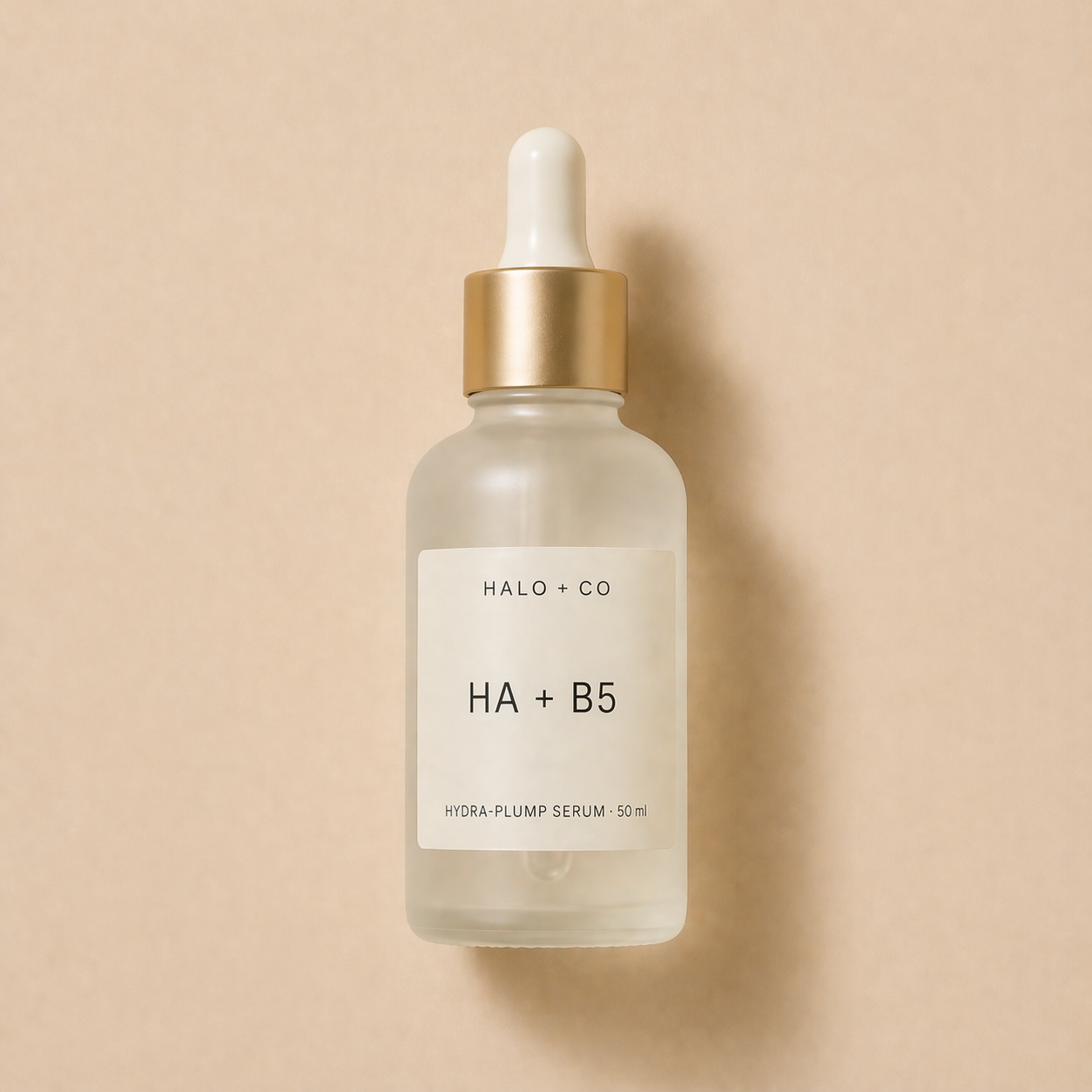 Halo + Co Hyaluronic Hydra-Plump Serum on warm beige background